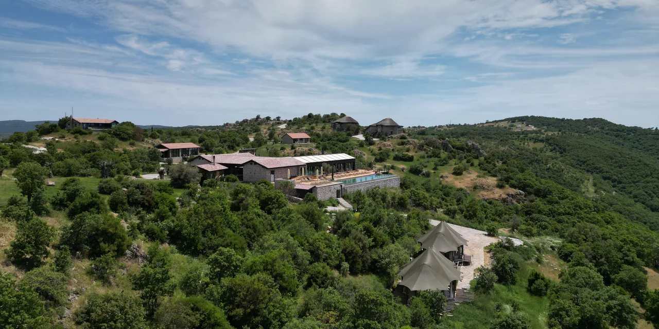 Manici Çiftlik on a Kaz Mountains hillside: stone buildings, the pool and safari tents among the trees